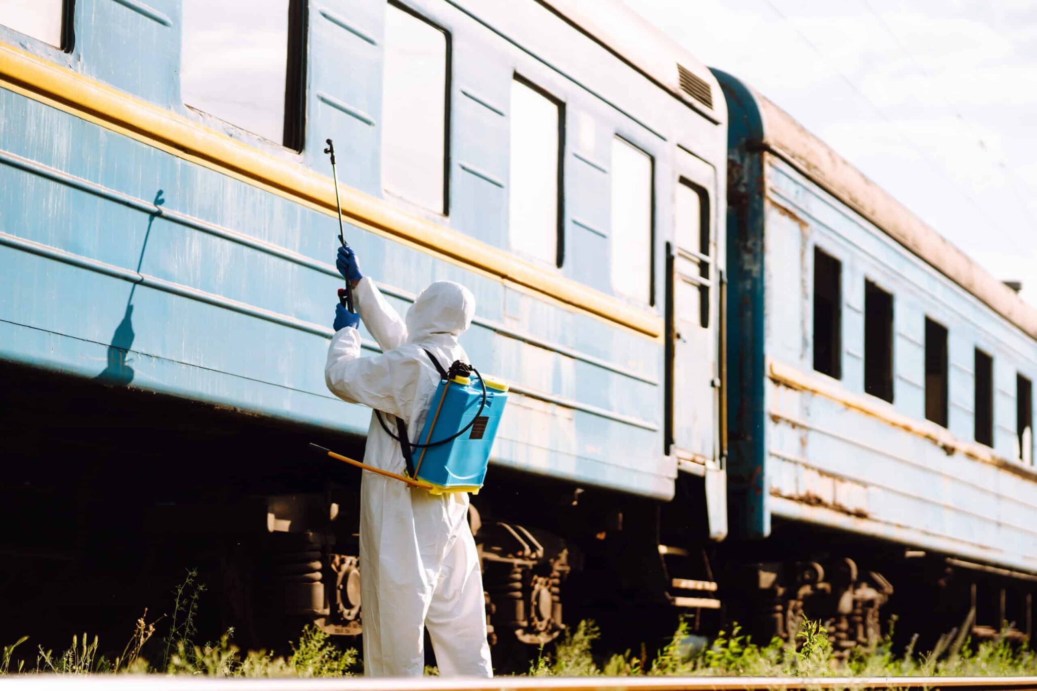 man-in-protective-suit-disinfects-train-young-man-2025-03-08-04-39-13-utc-scaled